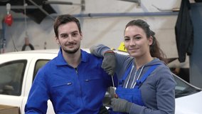 Portrait of apprentice standing in mechanics workshop