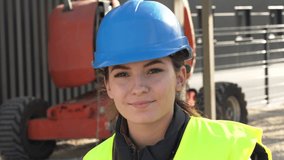 Portrait of woman apprentice standing on construction site