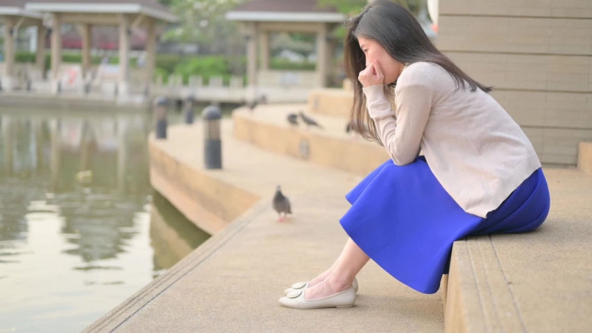 Asian woman sitting alone and depressed,Portrait of tired young woman. Depression