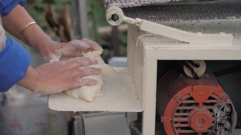 Woman make dough in Tortilla machine in Mexico. Mexican traditional taco