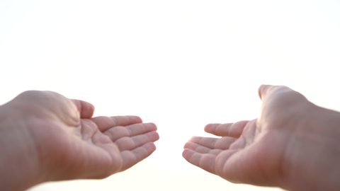 Point of view video shoot of two female outstretched hands raised up to white sunny sky. Slow motion full hd footage.