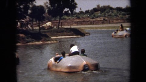 LAGUNA HILLS CALIFORNIA USA-1971: Two Hippo Rafts On A Lake With Kids And Adults Riding On Them