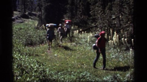 SAPPHIRE LAKE MONTANA USA-1977: Hikers Following Trail On Journey Through Nature Carrying Backpacks And Supplies