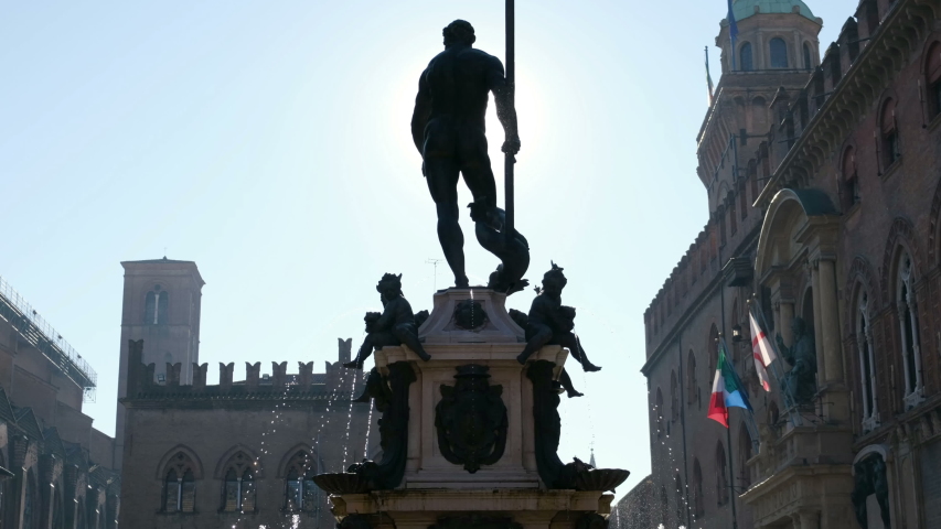 Bologna local landmark of Emilia Romagna region of Italy - the fountain of Neptune statue or Fontana del Nettuno in Piazza Maggiore in backlight .