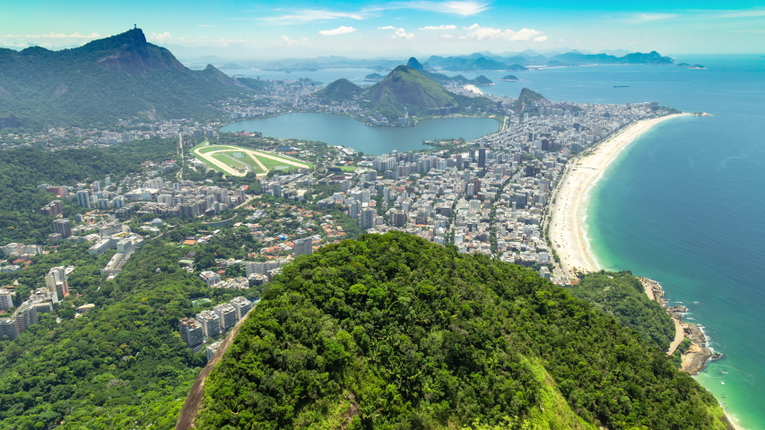 Aerial panorama timelapse of Rio de Janeiro, Brazil. View of Ipanema, Leblon, Lagoa lake, Copacabana, the beach and the ocean. Corcovado peak and mountains in the background.