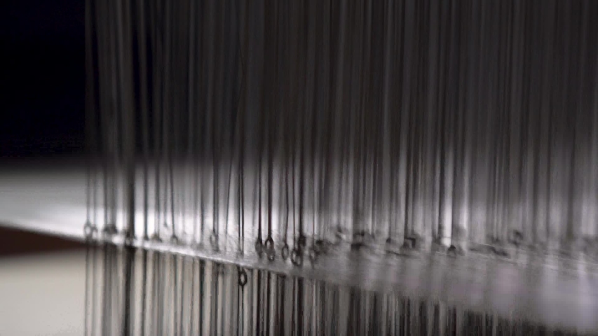 Closeup Of Cotton Thread Being Weaved In A Textile Factory. | Shutterstock HD Video #1044998563