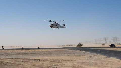 Police helicopter in the desert. Police training and rescue operation concept.