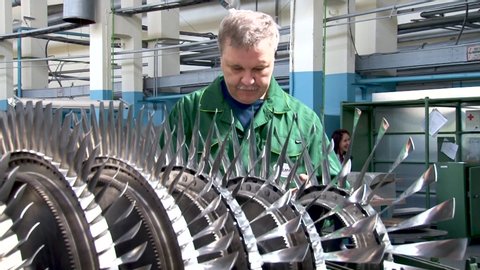 Ensk, Russia - July 16, 2013. Vintage video from  archive. Jet engine from Su-24 aircraft (Fencer) on repair slipway. Inspection of compressor rotor after repair. Hand rotation of compressor rotor.
