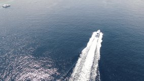 Cinematic 4k aerial video with dynamic motion of speeding boat near Nusa Penida Indonesia