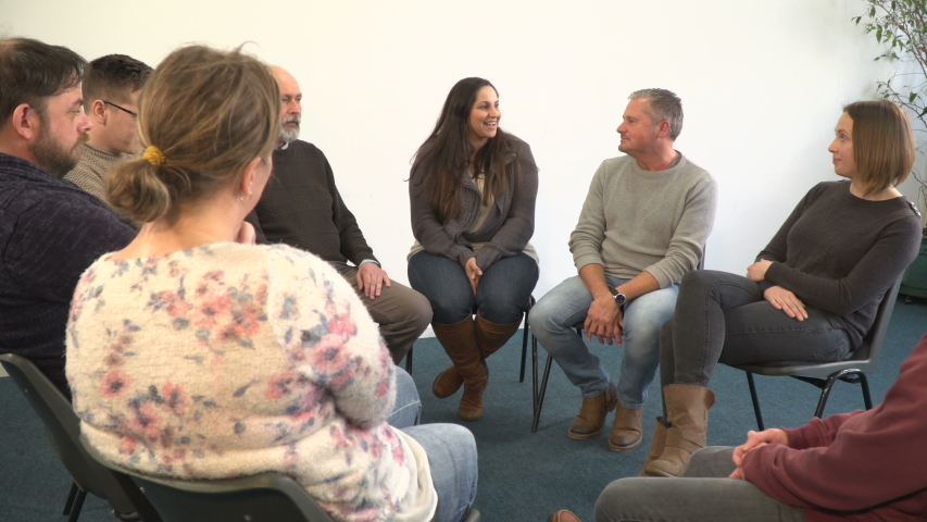 4K: Support group people sat in circle for therapy Counselling session - One woman talks while the others listen. Mental Heath, Alcoholic Royalty-Free Stock Footage #1045007695