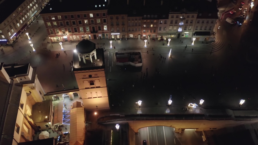 
Aerial view of the historic center of Warsaw at night in winter. 
The old city is beautifully illuminated by New Year