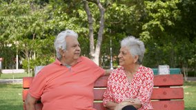 Happy old man giving flowers to his woman while celebrating valentine's day in a park. Senior Indian male surprising his beautiful aged wife with a bouquet of red roses on their marriage anniversar... - Powered by Shutterstock - Get 15% off with code: PIKWIZARD15