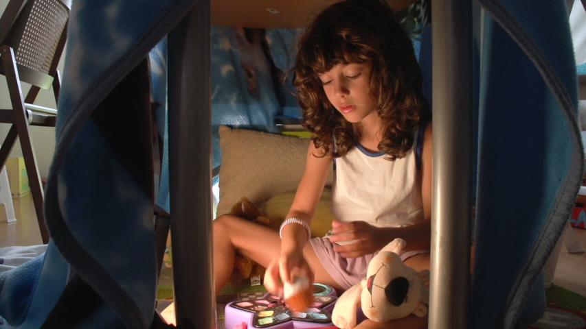 Child girl is taking care of her hands by a cosmetic cream FDV