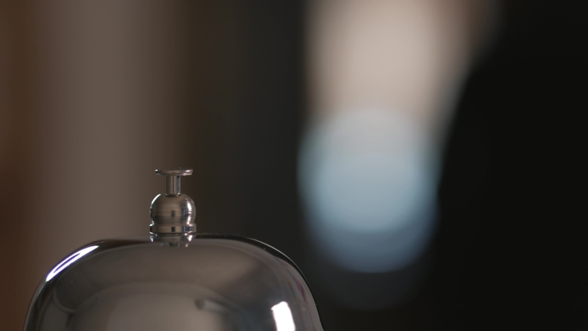 Close-up of a call to the front Desk of the hotel. Men finger presses the bell. Royalty-Free Stock Footage #1045020259