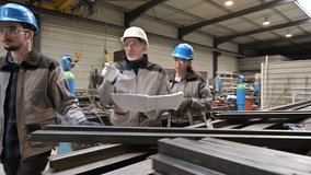 Steelwork instructor with young apprentice in workshop