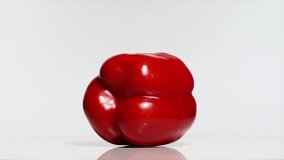 Red Bell Pepper with shadow on a white table, rotation 360 degrees. White background.Ultra high definition 3840X2160.4K resolution