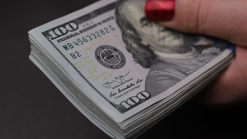 Women Counting a Lot of 100 Dollars