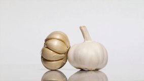 Garlic bulb with shadow on a white table, rotation 360 degrees. White background.Ultra high definition 3840X2160.4K resolution