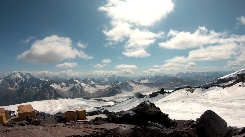 Landscape view of glacier and valley below Mount Elbrus. The highest point in Europe. Caucasus, Summer in Russia. 4K, Timelapse, Seamless video.