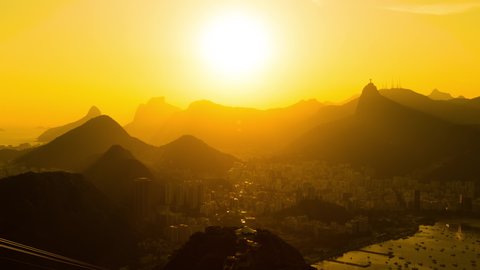 Day to night sunset timelapse of Rio de Janeiro, Brazil. View of the mountains, city downtown, Ipanema, Copacabana, Mount Corcovado and the bay and ocean.