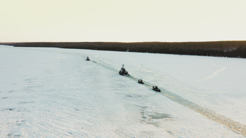 Tugboats break a path through the ice on their way to Sturgeon Bay, Wisconsin.