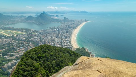 Aerial panorama timelapse of Rio de Janeiro, Brazil. View of Ipanema, Leblon, Lagoa lake, Copacabana, the beach and the ocean. Peak and mountains in the background. Rock and jungle in front.