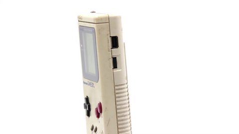 São Paulo, Brazil- January 19, 2020: A studio video of a Nintendo handhel videogame gameboy spinning  isolated on a white background.