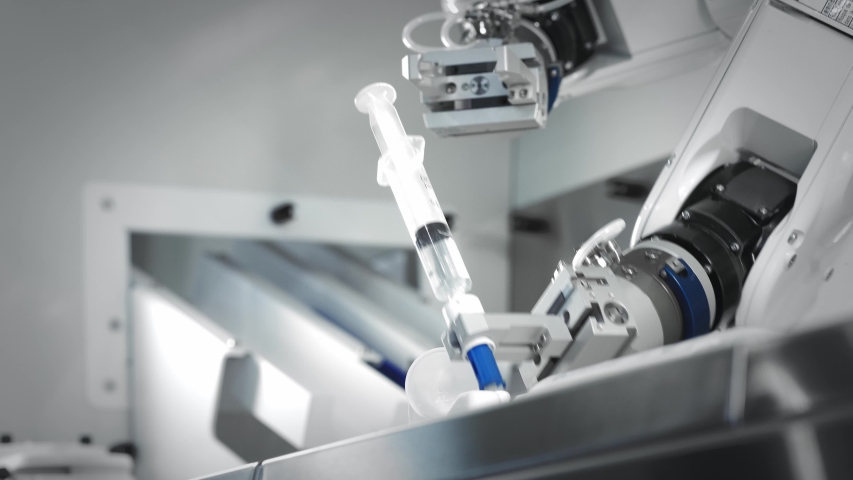 The innovative arms of a robotic arm make an injection of chemotherapy for a cancer patient. New technologies in medicine. Two manipulators draw medicine into a syringe. Hazardous substance injected