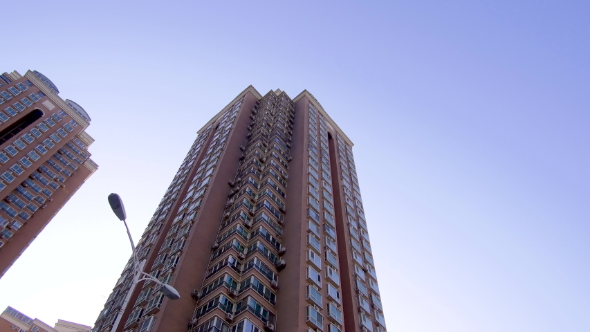 Looking up of skyscraper with camera moving street. Beijing, China.