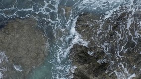 Ocean wave splash foam on the rock stone aerial top view footage 4k video 