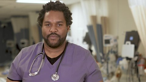 Portrait of a confident black male nurse, close-up in a hospital ward.