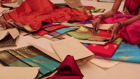 Cloth seller showing Saree to the customers in a shopping mall / shop - paithani saree  - Powered by Shutterstock - Get 15% off with code: PIKWIZARD15