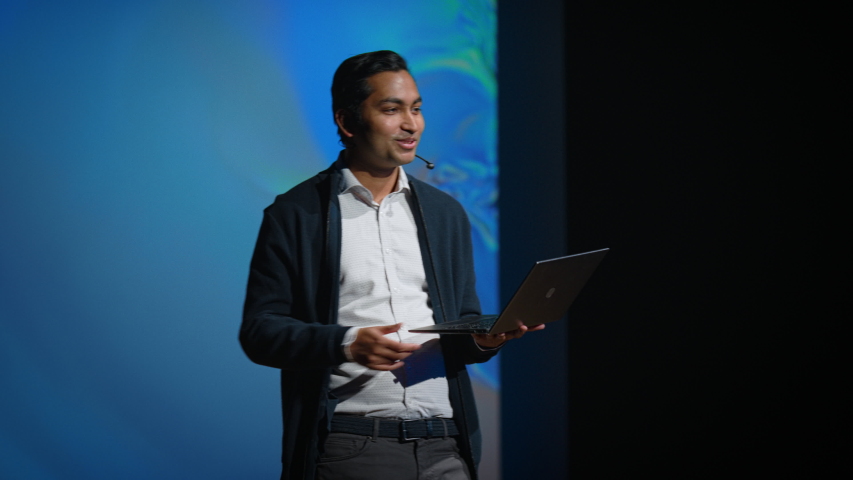 Business Conference Stage: Indian Tech Startup Chief Engineer Presents Firm's Newest Product, He's Holding Laptop and Does Motivational Talk about Science, Technology, Entrepreneurship, Software  | Shutterstock HD Video #1045102456