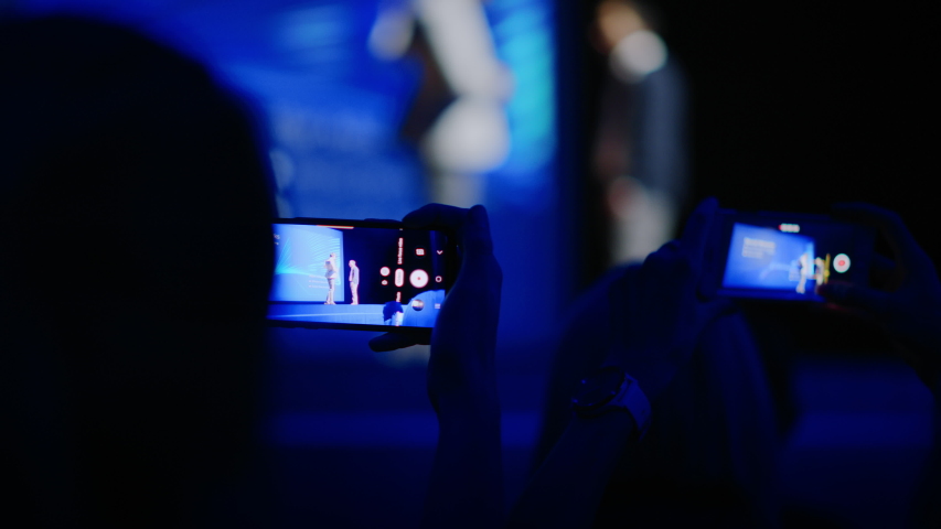 Audience Use Smartphones to Record Two Speakers on Stage Talking on Business Conference. In Audience Hall Public Uses Mobile Phones to Shoot Video of Two Star Presenters, Live Event, Tech Symposium Royalty-Free Stock Footage #1045102513