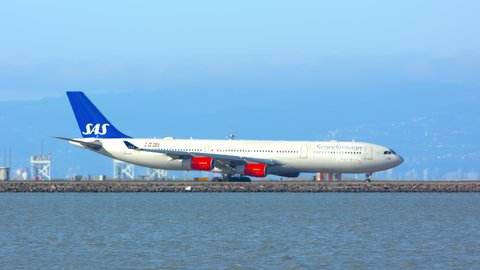SAN FRANCISCO, CA - 2020: SAS Scandinavian Airlines Airbus A340 Jet Airliner Taxiing Across the San Francisco Bay Area Heat Waves at SFO International Airport on a Sunny Day in California