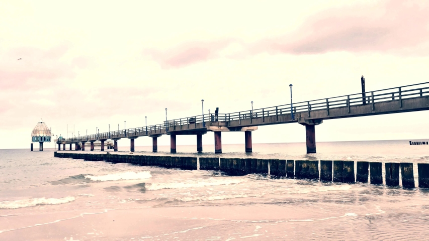Minimalist misty seascape with sea bridge.