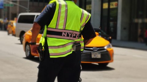NEW YORK CITY - Circa June, 2015 - A New York police officer directs traffic.