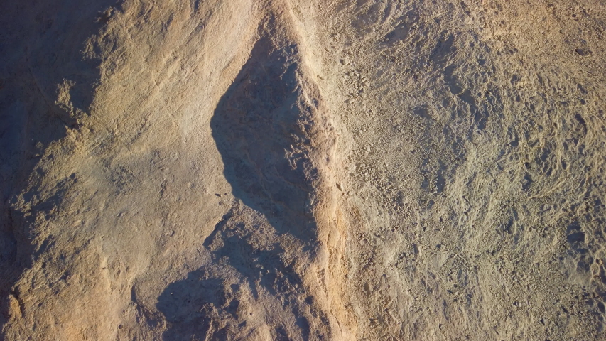 Sexy curvy woman admires the Landscape from the top of Zabriskie Point in Death Valley National Park in California. It is one of the hottest places in the world. Gimbal panning cinematic ProRes 422 4K