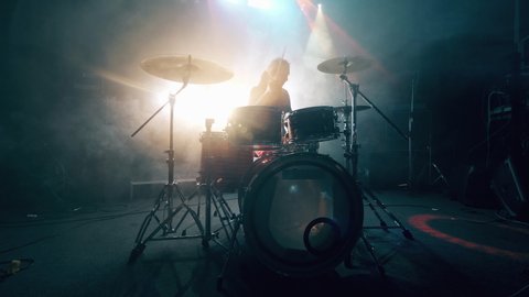 Dark music studio and a man playing drums