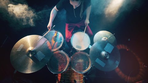 Top view of a drum kit getting played by a musician