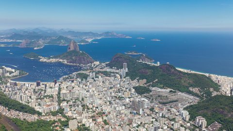 Panning aerial timelapse hyperlapse of the Sugarloaf mountain in Rio de Janeiro, Brazil. View  of Ipanema, Copacabana, Botafogo. Boats and ships traffic in Guanabara bay. Peak and hills.
