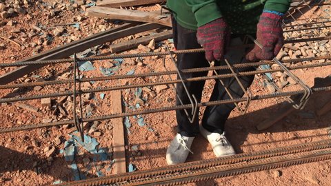 Muadzam Shah, Malaysia - January 22th, 2020 : Construction workers fabricating upper beam  reinforcement bar at the construction site. The reinforcement bar was tied together using tiny wire.