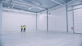 Industry 4.0 Modern Factory: Two Engineers Use Digital Tablet Computer with Augmented Reality Software Visualizing of Manufacturing Plant Room Mapping, Factory Layout. Illustrative Mock-up Concept - Powered by Shutterstock - Get 15% off with code: PIKWIZARD15