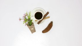 Hot black coffee on the table, coffeepot, glasses, a dish on a white background, various sweets, baked, chocolate, natural flowers, white English services. Rotating, 1920x1080. FHD.