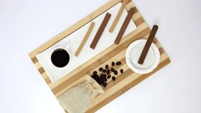 Top view spinning video of coffee cup with sweet sticks and coffee beans. FHD.