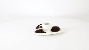Coffee cup with candies and coffee pot on spinning table background. Beautiful white & wooden decoration, hot, natural organic drink, sweet cakes. 1920x1080. FHD.