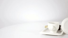 Coffee cup with candies and coffee beans and flower on spinning table background. FHD.