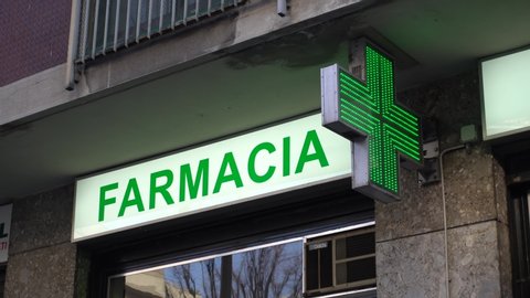 Italy , Milan January 23,2020 pharmacy green neon sign