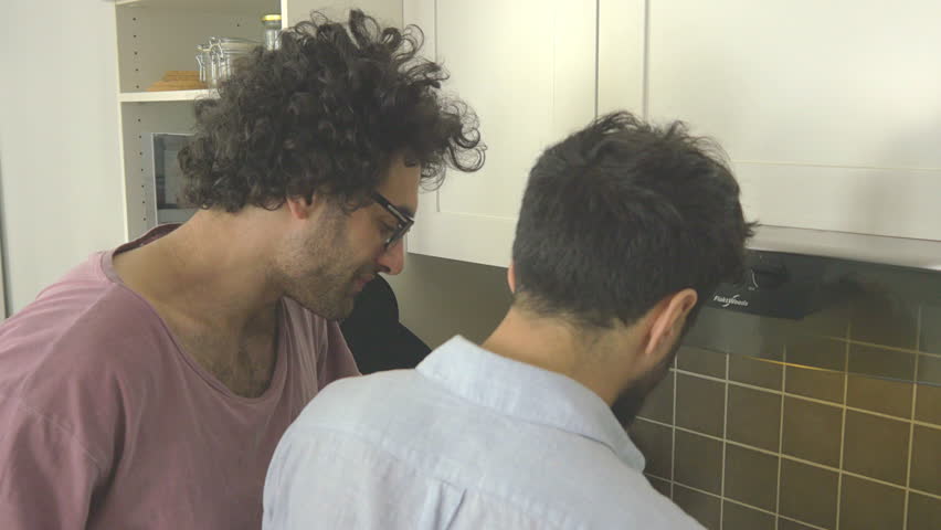 Gay couple making breakfast and kissing, model release supplied. Filmed by Noofoo Media.