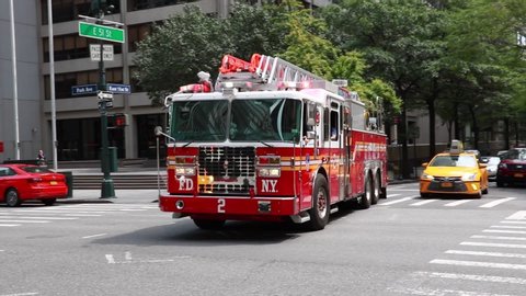 NEW YORK CITY, USA - September 3, 2018: FDNY EMS firefighters rode to the scene with flashing lights on a New York street.